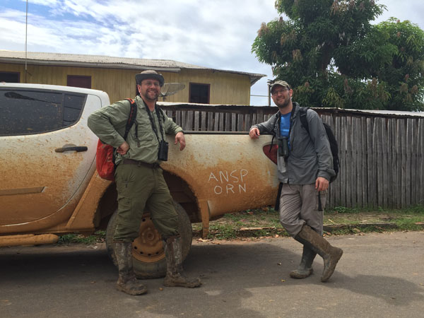 Scientists with dirt-covered truck