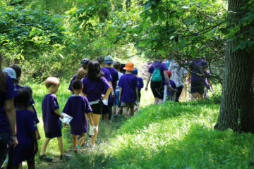 Academy Science Campers hike through the woods