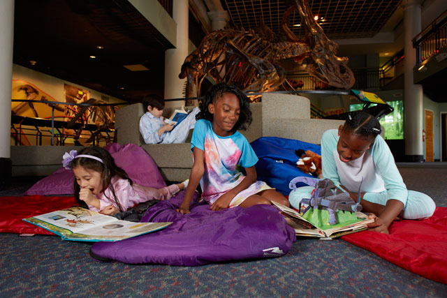 Girls enjoy indoor family fun at a dinosaur museum overnight