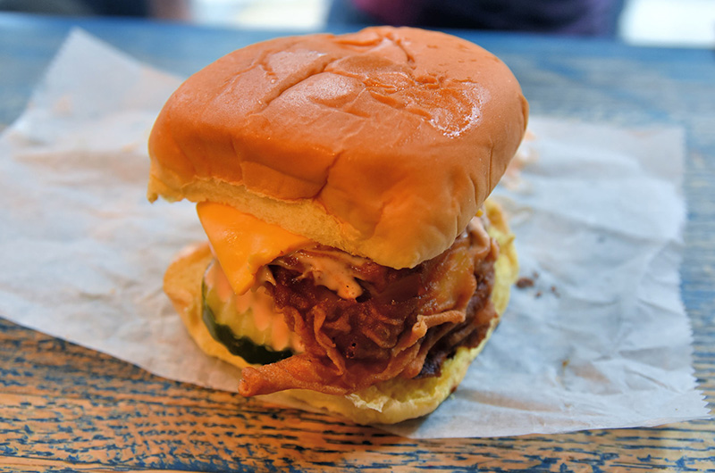 Fried chicken with orange cheese on soft roll