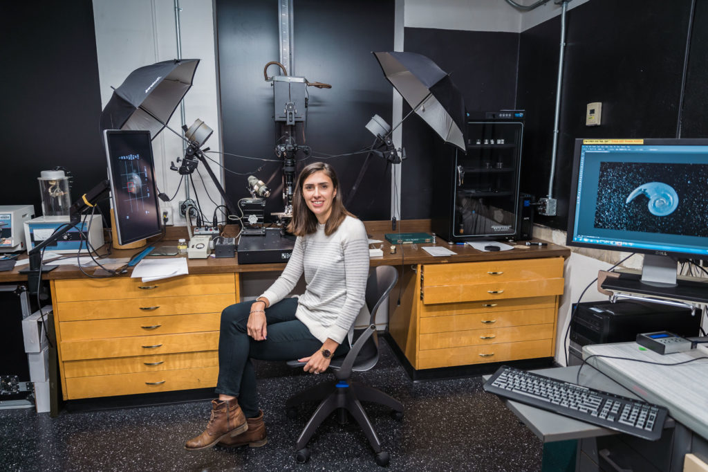 Female scientist in front of scanning equipment
