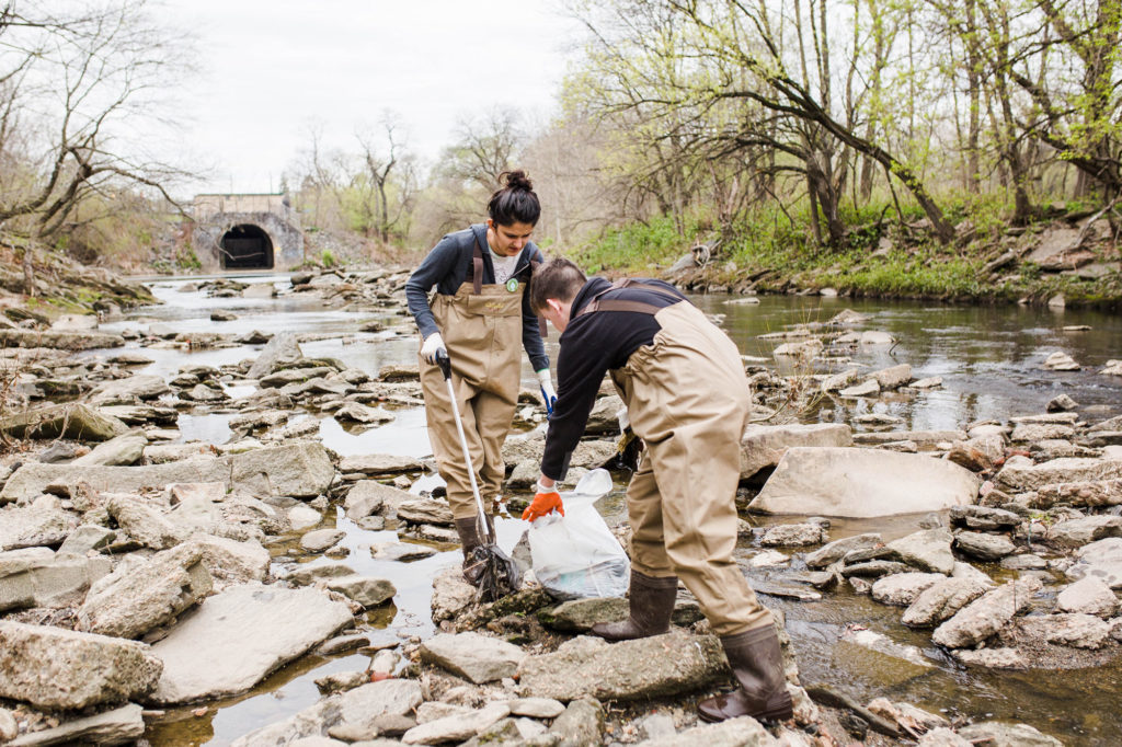 Young adults pick up trash at Frankford Creek