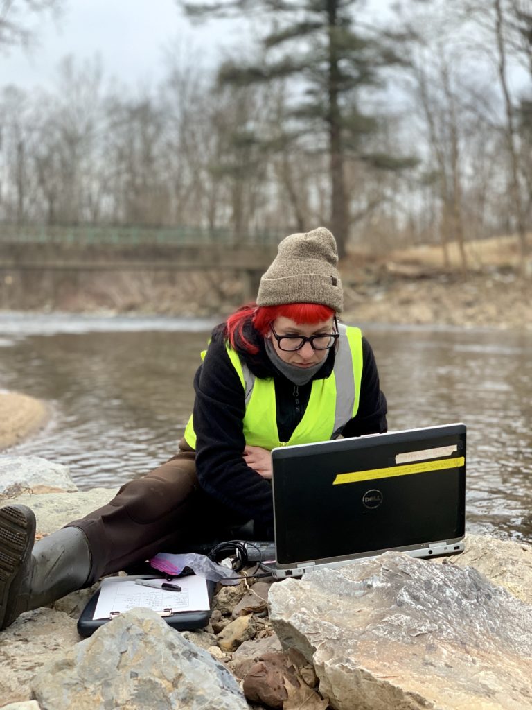 woman at stream w laptop