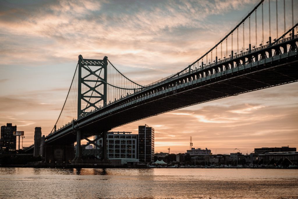 Ben Franklin bridge in Philadelphia illuminated by sunset
