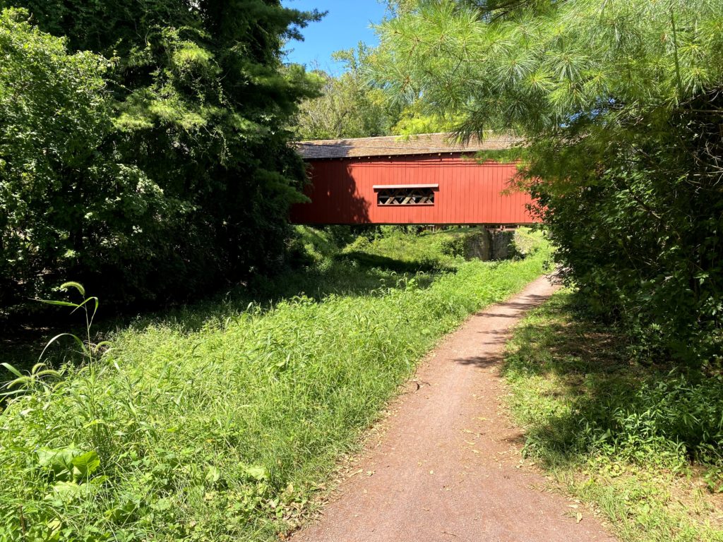 covered bridge along a dirt path