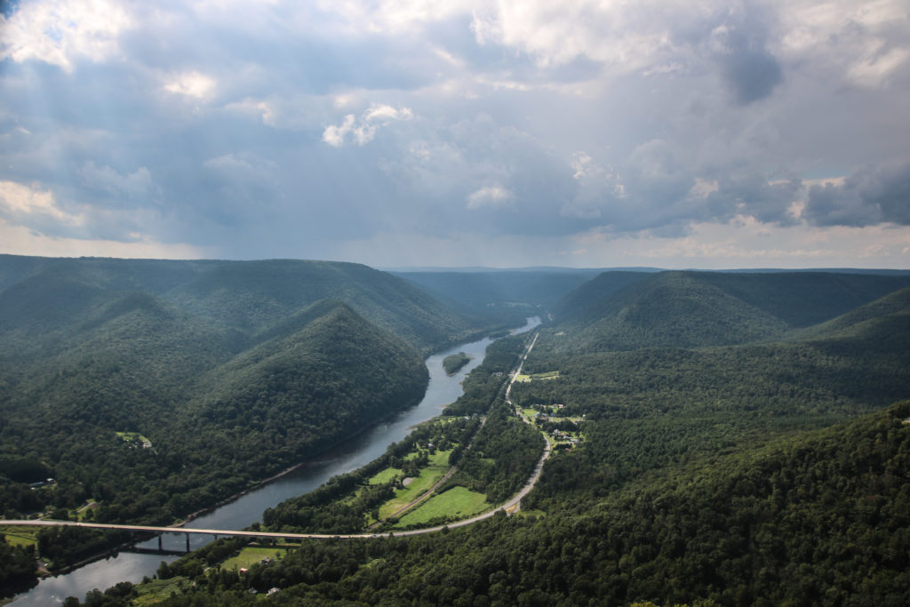 view from vista looking at green mountains with bridge below