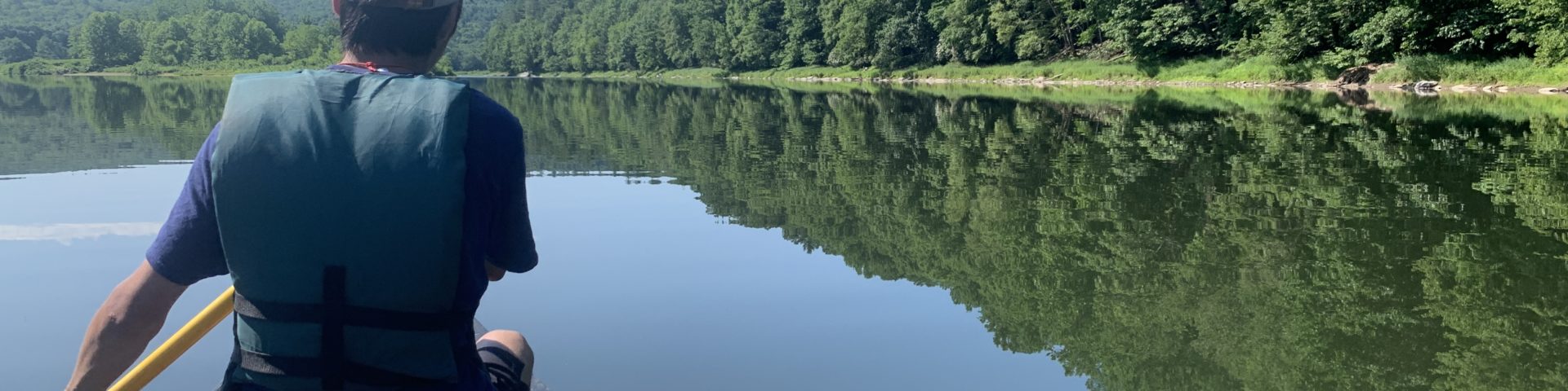 person on canoe on river