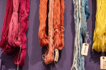 colored yarn hanging on wall